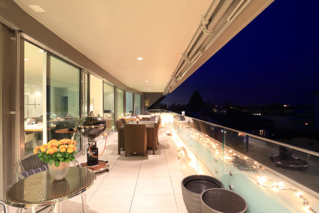 Villa facade at dusk with glowing windows