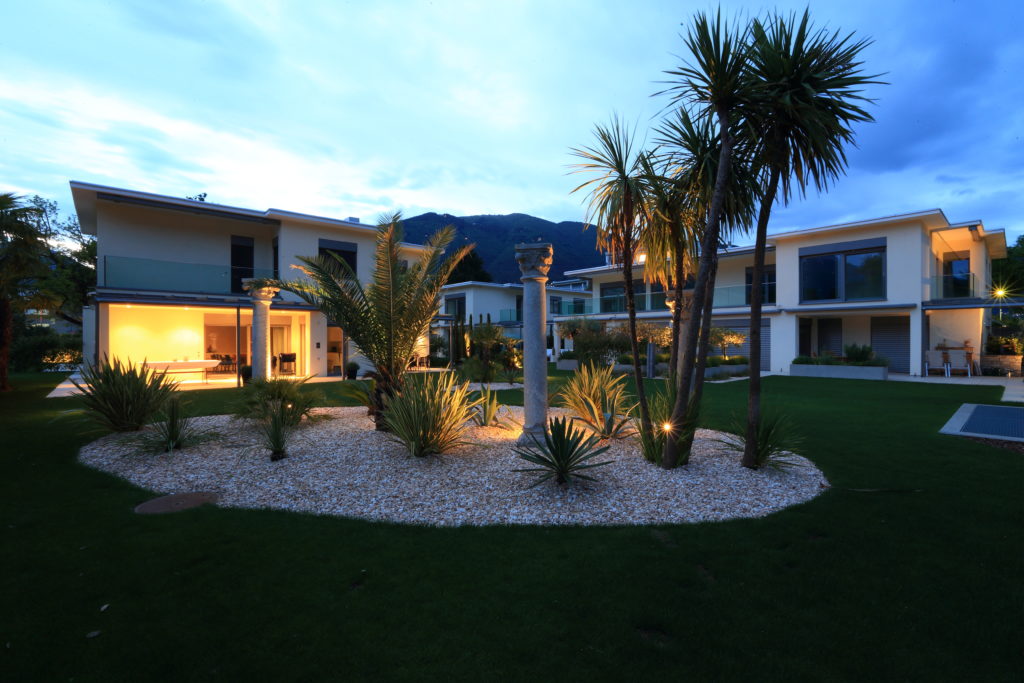 Homes nestled among tall palm trees