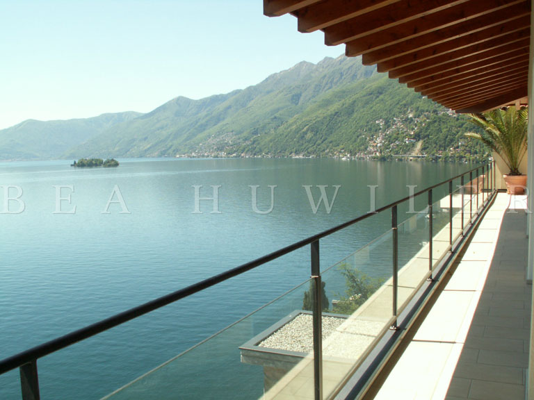 Lakefront walkway with benches and lamps